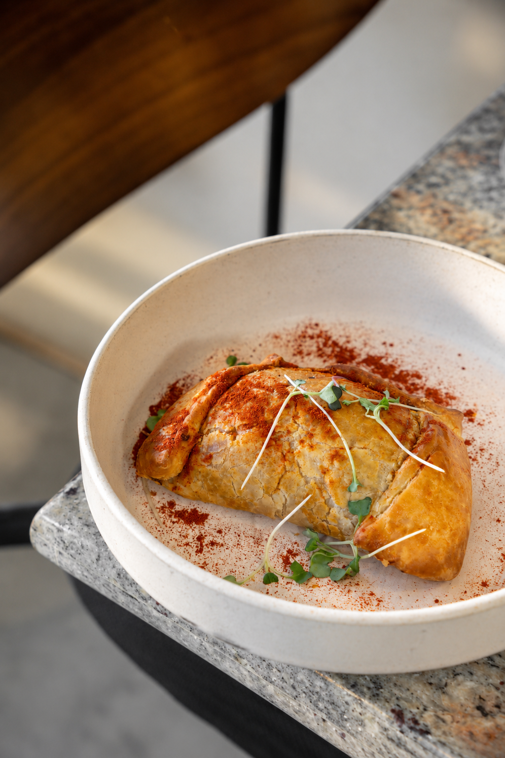 Golden empanada with microgreens